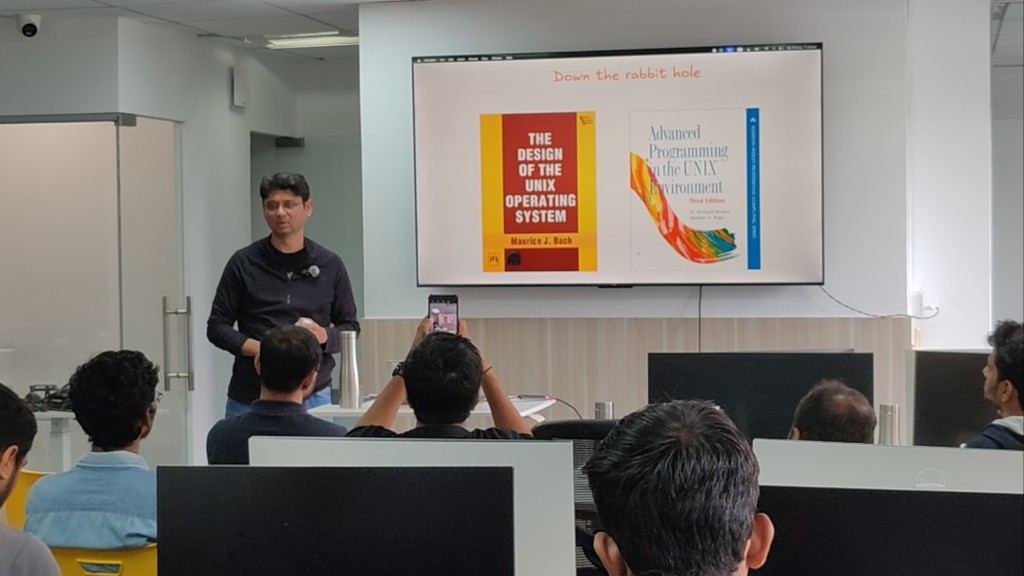 Speaker presenting UNIX book references during Episode 1