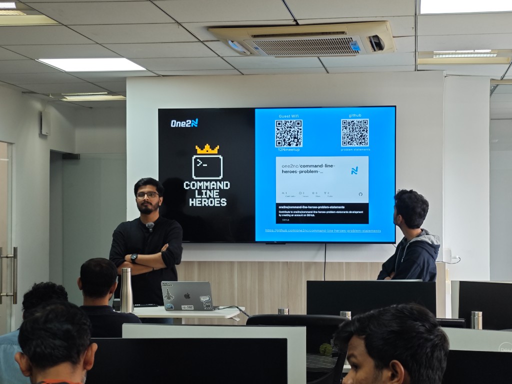 Speaker presenting Command Line Heroes resources and QR links on screen