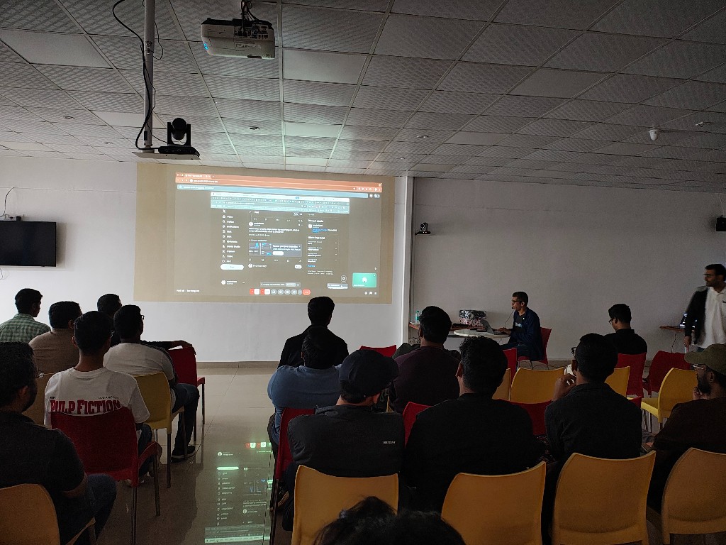 Audience watching a projected terminal session at Command Line Heroes Episode 3 in Bengaluru