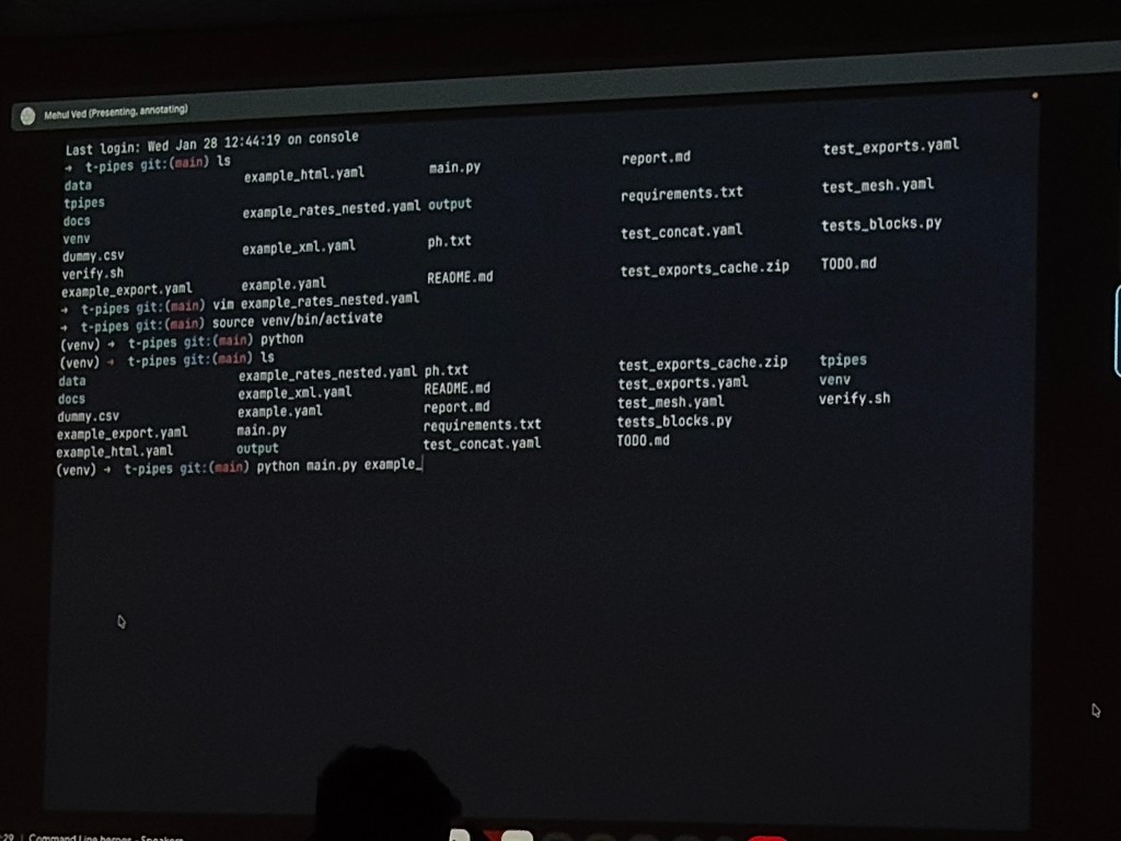 Projected terminal screen showing file operations and command output during Episode 3