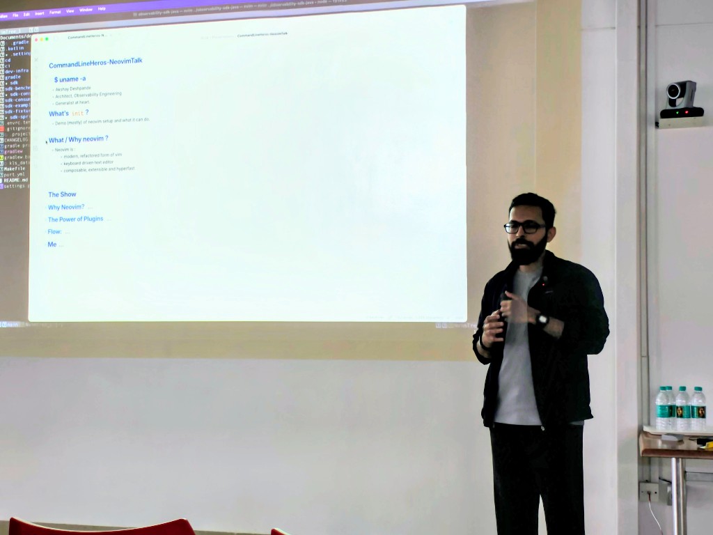 Presenter speaking beside projected Neovim talk notes at Episode 3